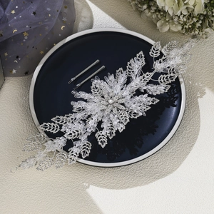 Macro detail of luxury crystal bridal headband with silver leaf rhinestones and hair clips