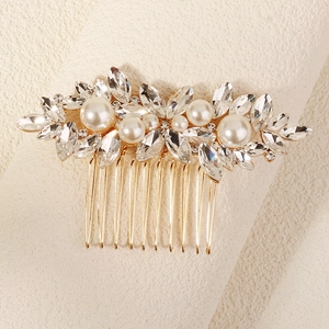 Detail of luxury bridal hair comb with pearls and marquise rhinestones on gold metal base