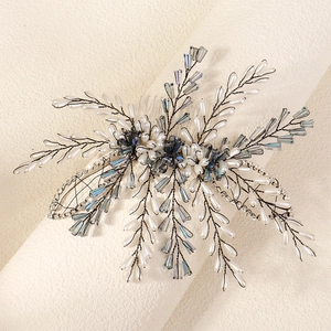 Detail of handcrafted bridal hair comb with blue crystals and white pearls for parties