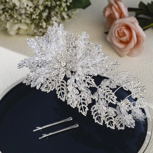 Macro shot of luxurious bridal headband featuring crystal leaves and silver rhinestones