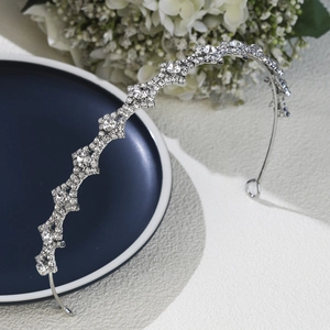 Detailed close-up of a silver bridal headband with geometric star rhinestone patterns