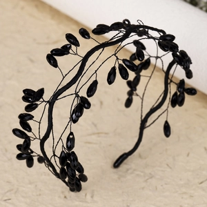 Close-up of handmade black beaded headband with crystal branch-like texture