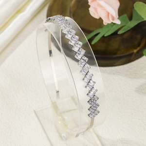 Detailed side view of silver metal headband with geometric crystals on display stand