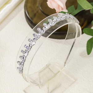 Macro detail of silver headpiece with marquise-cut zircon crystals and wavy design