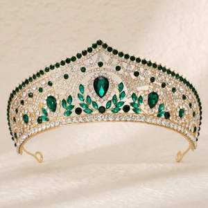 Luxurious gold bridal crown featuring large emerald green crystals and white rhinestones