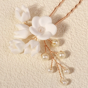 Eleganter Brauthaarschmuck mit weißen Tonblüten und Perlenquasten für Hochzeitsfrisuren