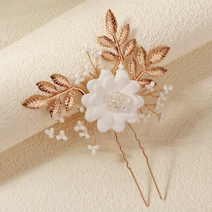 Golden bridal hair pin with white resin flowers and pearl leaves for wedding hairstyles