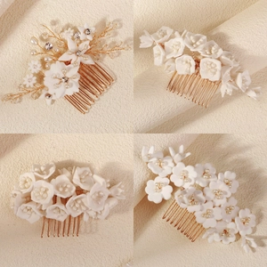 Detailed close-up of handmade white clay flower hair combs with pearls and crystals