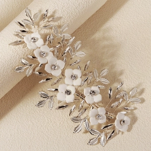 Detail of silver leaf hair clip with white resin flowers and sparkling crystals