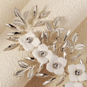 Silver bridal hair clip with white matte flowers and sparkling crystals for wedding hairstyles
