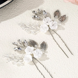 Elegant pair of handmade white ceramic flower hair pins with crystals and silver leaves