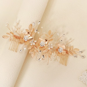 Vue détaillée du peigne à cheveux doré pour mariée avec perles, cristaux et feuilles