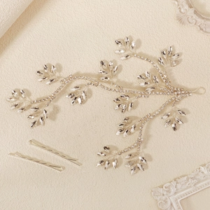 Detailed close-up of bridal vine headband with marquise rhinestones and two silver hair clips