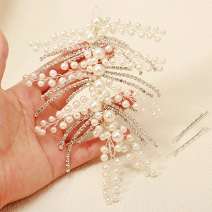 Luxurious silver bridal hairpiece with handmade pearls and rhinestones leaf design