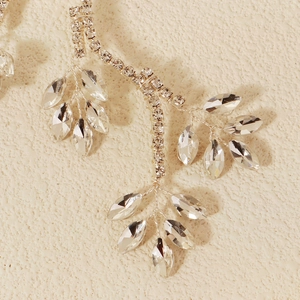 Bridal leaf hairband with sparkling rhinestones and silver twig design on beige texture
