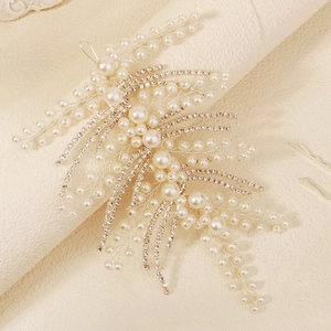 Detailed macro view of handmade bridal hairband with pearls and crystal leaf accents