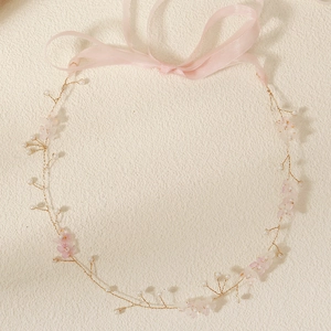 Detail of bridal headband with handmade pink silk flowers, white pearls and chiffon ribbon
