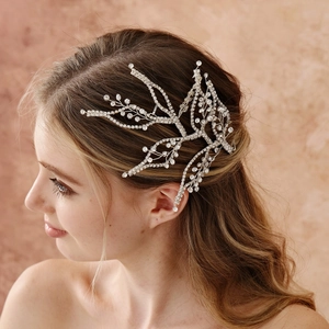 Detail of elegant silver leaf bridal headpiece with sparkling crystals on side hair style