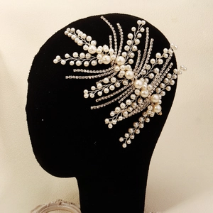Detail showing bridal hair accessory with white pearls and sparkling rhinestones