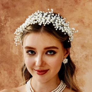 Detailed view of handcrafted bridal headband with intricate white pearls and matching jewelry