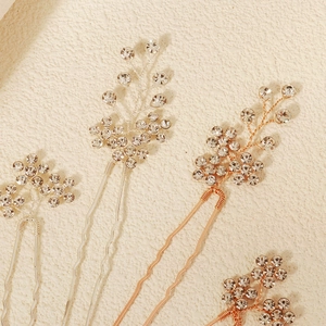 Detailed close-up of sparkling rhinestone flower hair pins for elegant bridal styling