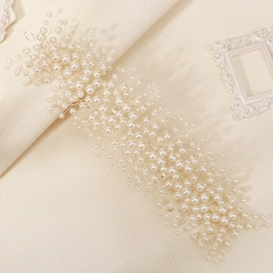 Detail of handcrafted bridal hair vine with delicate white pearls and silver wire weave