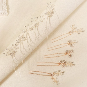 Detailed view of U-shaped bridal hair pins with shimmering rhinestones in three metallic colors