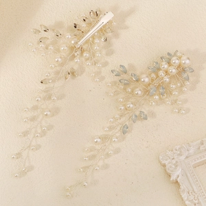 Detail of silver bridal hair clips with pearls and crystal tassels for wedding styling