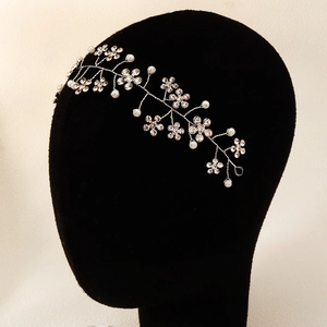 Detailed view of handmade silver bridal hairband with crystal flowers and pearls