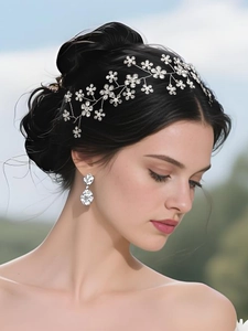 Detail of silver floral bridal headband with crystals and pearls on elegant updo