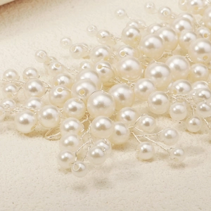 Detail of handmade bridal headband with pearls and silver wire in a floral branch design