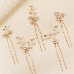 Detailed set of five rose gold bridal hair pins with sparkling crystals and metal branches