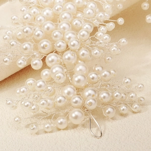 Detail of handcrafted bridal headband with white pearls and silver woven branches