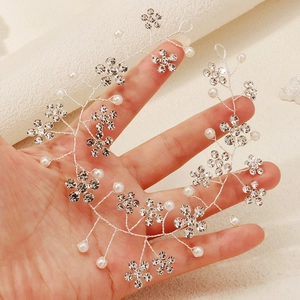 Elegant silver bridal headband with sparkling rhinestones and white pearls floral design