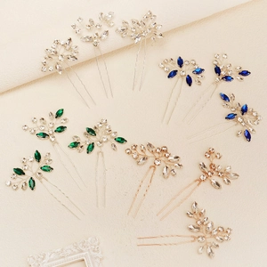Macro detail of bridal hair pins with marquise crystals and twisted wire flower design