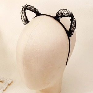Detailed view of black lace cat ear headband featuring intricate floral hollow patterns