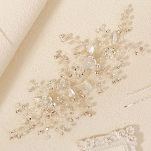Detailed close-up of handmade bridal headband with silver wire, pearls and resin flowers