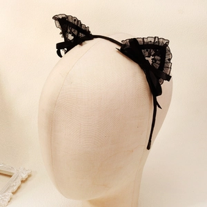 Detail of black lace cat ears headband with elegant satin ribbon bow on a model head