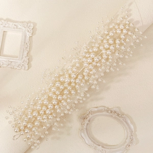 Elegant bridal hair vine with white pearls and silver wire on a vintage background
