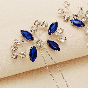 Macro detail of handmade silver hair pins with navy blue marquise crystals and rhinestones