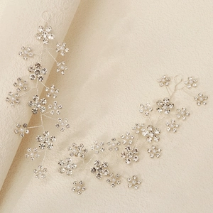 Detailed view of bridal hair vine with silver wire weave and sparkling rhinestone flowers