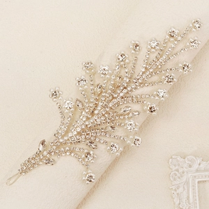 Detail of bridal headband with silver leaves, sparkling rhinestones and white pearls