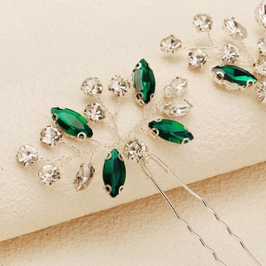 Detail of silver bridal hair pin with green marquise rhinestones and handmade wire leaves