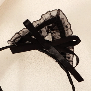 Detail of black lace cat ears headband with satin ribbon bow for party cosplay costumes