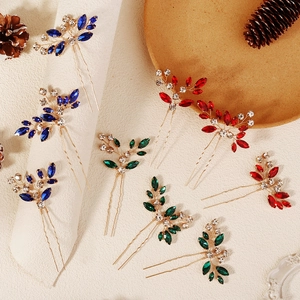 Detailed view of handmade bridal hair pins with marquise crystals in red, blue and green