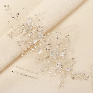 Elegant silver bridal headband with pearls, rhinestones and floral leaf design for wedding hair