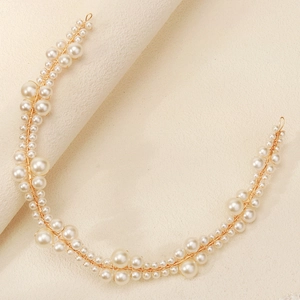 Detailed macro view of handmade white bridal pearls woven with delicate gold wire