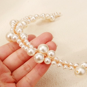 Elegant handmade bridal headband featuring white pearls and golden metallic wire detail