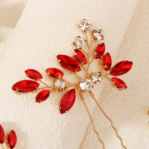 Detailed macro view of handmade gold wire hair pin with red marquise rhinestones