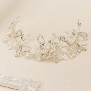 Gros plan sur un bandeau de mariée fait main avec perles blanches et strass brillants